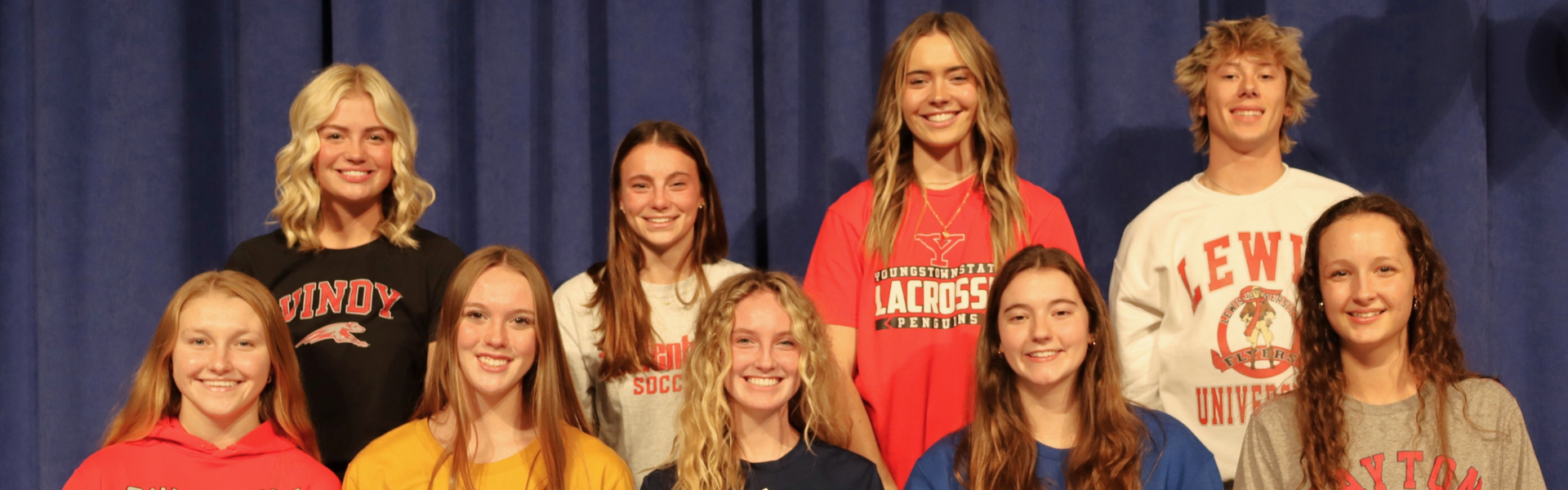 Kings athletic signing day. 9 student athletes pictured in a group.
